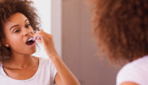 woman brushing her teeth