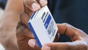 person holding medication box